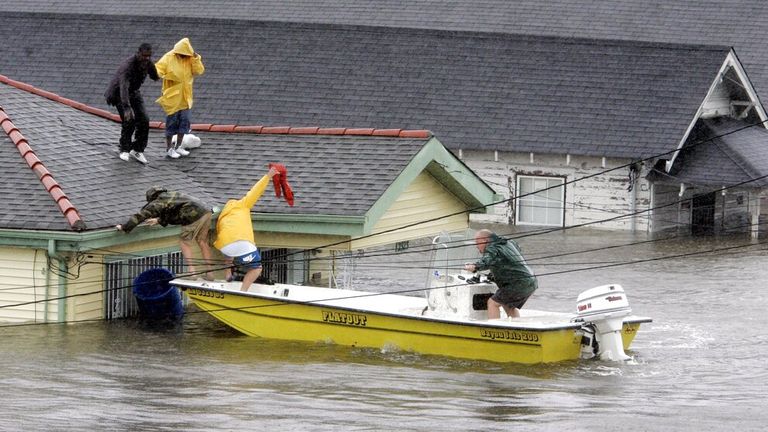 New Orleans residents rescued from their rooftop after Hurricane Katrina triggered devastating floods Pic: AP