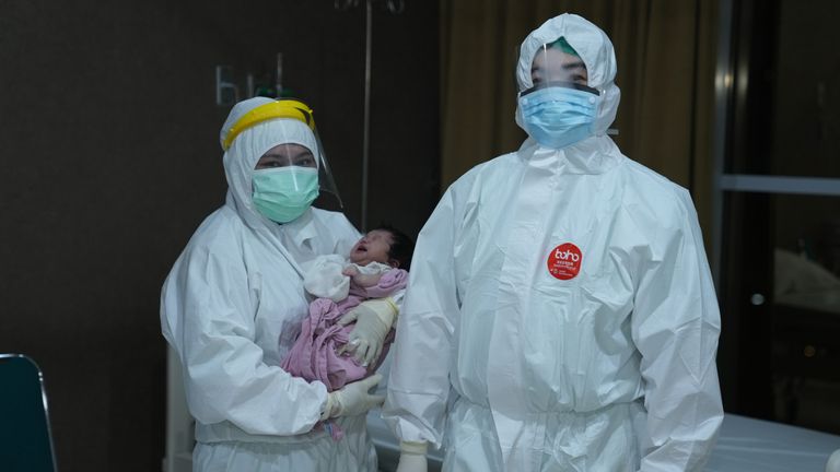 Dr Agus Susanto, a paediatrician at a hospital in Jakarta, and a nurse with a child