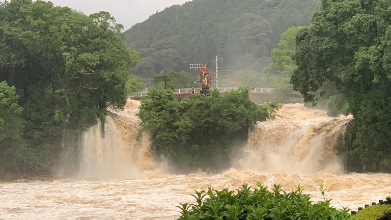 Muddy water cascades during floods at Todorokinotaki water park in Ureshino city, Saga Prefecture. Pic: @KNOMOEMON321/via Reuters