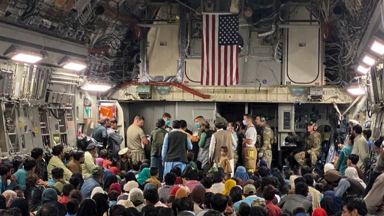 FILE PHOTO: A newborn baby is looked after prior taking off with other Afghan evacuees on a C-17 Globemaster III at a Middle East staging area August 23, 2021. Picture taken August 23, 2021. U.S. Air Force//Handout via REUTERS THIS IMAGE HAS BEEN SUPPLIED BY A THIRD PARTY./File Photo