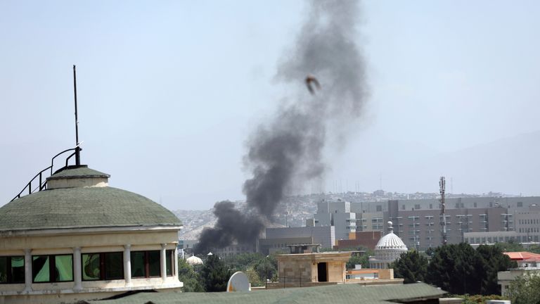 Smoke rises next to the U.S. Embassy in Kabul, Afghanistan, Sunday, Aug. 15, 2021. Helicopters are landing at the U.S. Embassy in Kabul as diplomatic vehicles leave the compound amid the Taliban advanced on the Afghan capital. (AP Photo/Rahmat Gul).