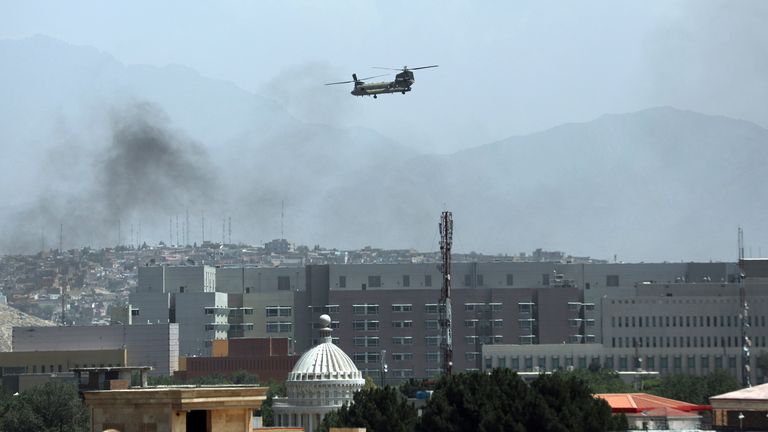 A U.S.Chinook helicopter flies over the city of Kabul, Afghanistan, Sunday, Aug. 15, 2021. Helicopters are landing at the U.S. Embassy in Kabul as diplomatic vehicles leave the compound amid the Taliban advanced on the Afghan capital. (AP Photo/Rahmat Gul).