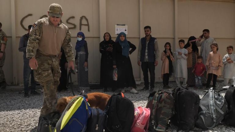 Security checks o the bags of those Afghans being evacuated from Kabul