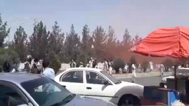 Coloured smoke is seen near the entrance to the Hamid Karzai International Airport, in Kabul, Afghanistan, August 28, 2021, in this still image obtained from a social media video. AAMAJ News Agency/via REUTERS THIS IMAGE HAS BEEN SUPPLIED BY A THIRD PARTY. MANDATORY CREDIT.