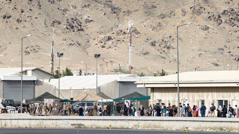 Australian citizens and visa holders queue up to board the Royal Australian Air Force C-17A Globemaster III aircraft, as Australian Army infantry personnel provide security, at Hamid Karzai International Airport in Kabul, Afghanistan August 22, 2021. SGT Glen McCarthy/ Australia&#39;s Department of Defence/Handout via REUTERS. ATTENTION EDITORS - THIS IMAGE WAS PROVIDED BY A THIRD PARTY. NO RESALES. NO ARCHIVES.