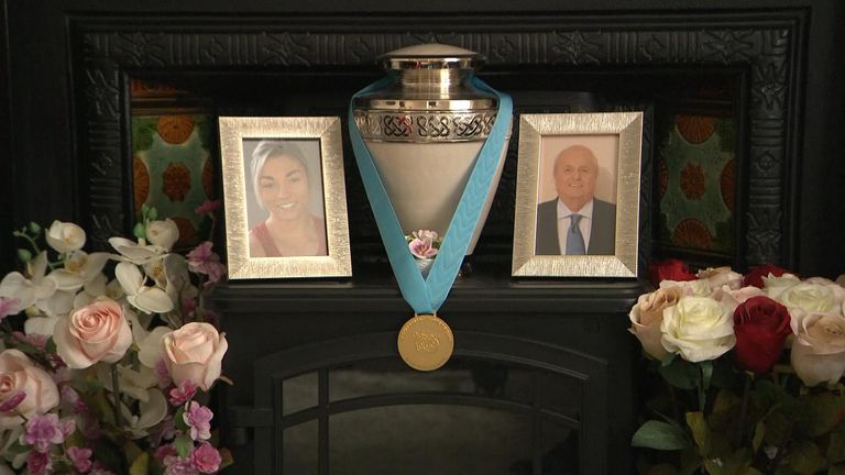 The Olympian&#39;s gold medal sits between a framed picture of herself and her late grandfather