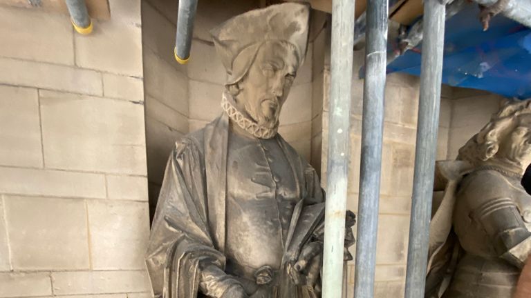 Des statues en pierre détaillées et une gargouille se dressent dans tout le bâtiment