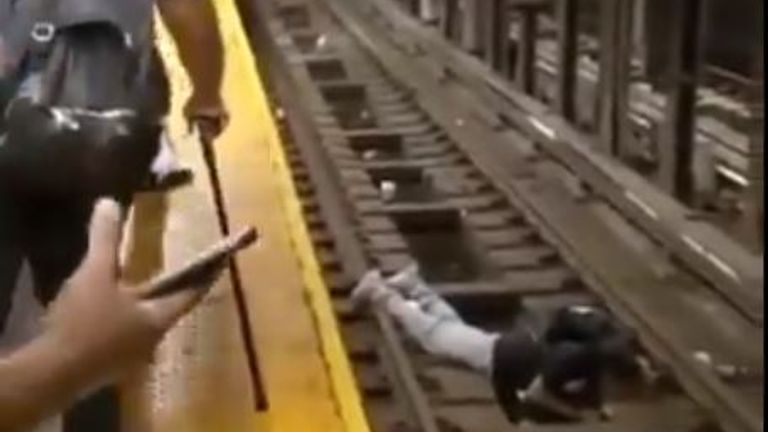 A stricken passenger lays prone on the tracks at the subway station in the Bronx, New York