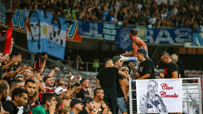 Nice fans cheer on their side as the travelling Marseille fans are pictured in the background