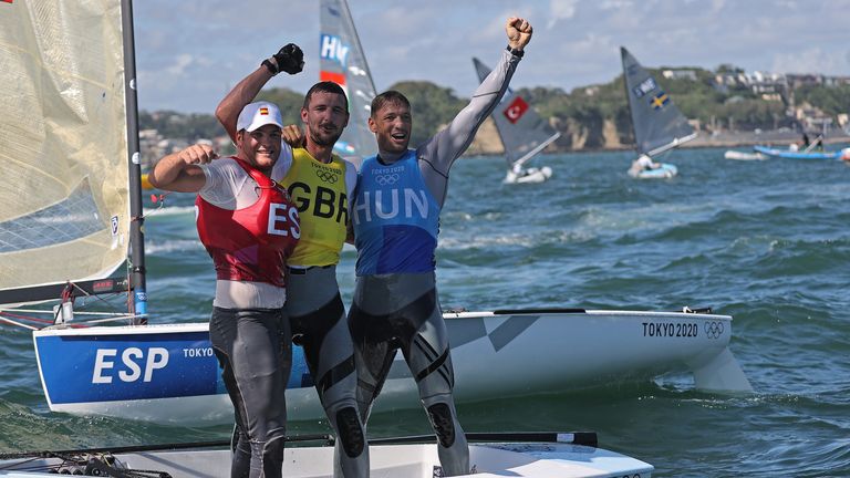 Team GB&#39;s Giles Scott celebrates his Finn class gold medal with Joan Cardona of Spain and Hungary&#39;s Zsombor Berecz, who pushed Scott all the way