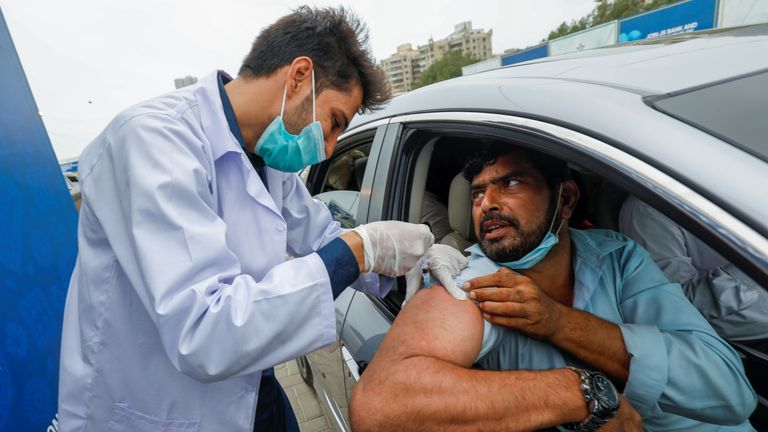 FILE PHOTO: A resident receives a vaccine against coronavirus disease (COVID-19) at a drive-through vaccination facility in Karachi, Pakistan July 29, 2021. REUTERS/Akhtar Soomro/File Photo