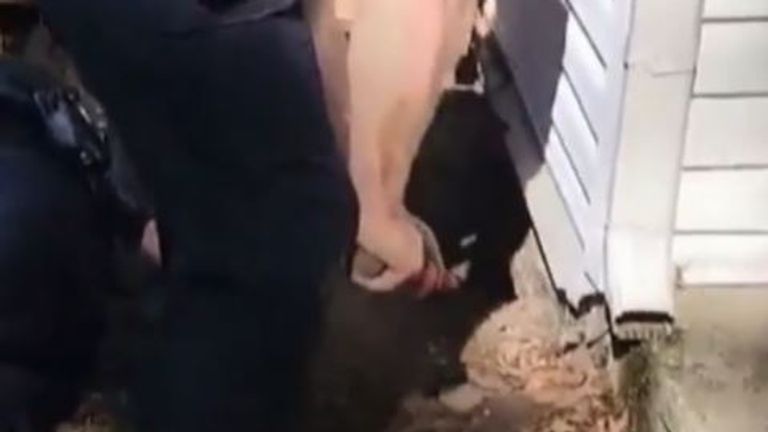 Police rescue a dog trapped under a house