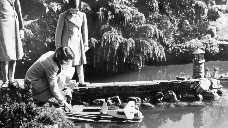 Elizabeth and Margaret launch a model seaplane at the Bekonscot model village in Beaconsfield, Buckinghamshire in 1939