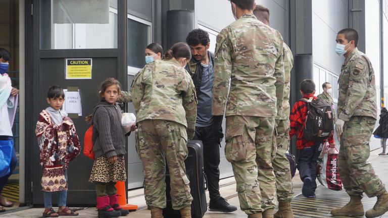 Refugees from Afghanistan board buses at Ramstein air base. The buses will take them to planes that will, in turn, take them to the US    