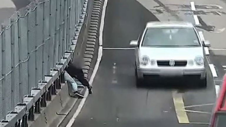 Man is recorded crossing busy road in highly dangerous fashion