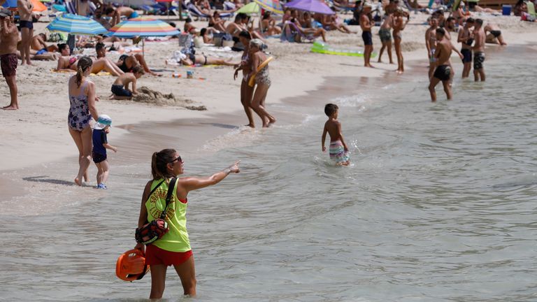 Locals and tourists cool off in the sea in Mallorca as Spain potentially recorded its hottest temperature ever