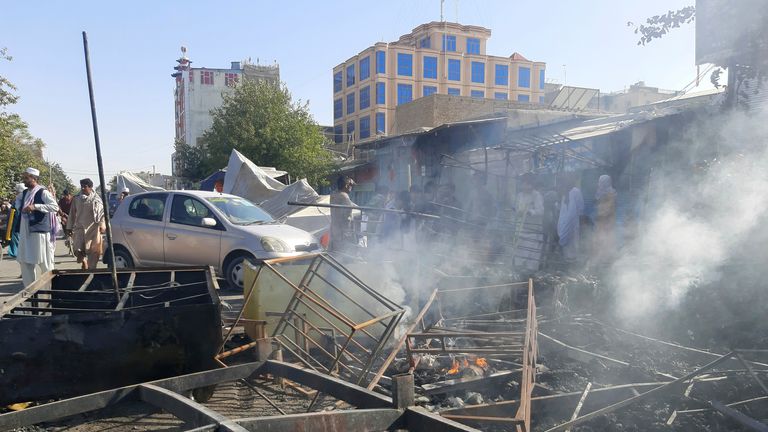 Smoke rises from damaged shops in Kunduz