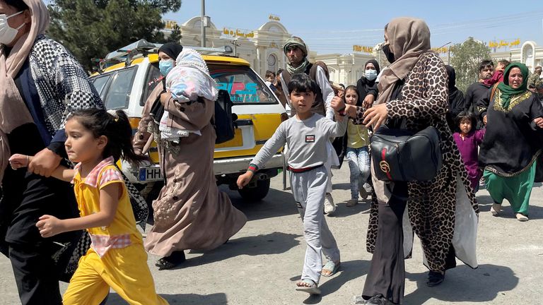 Women with their children try to get inside Hamid Karzai International Airport in Kabul, Afghanistan August 16, 2021. REUTERS/Stringer NO RESALES. NO ARCHIVES
