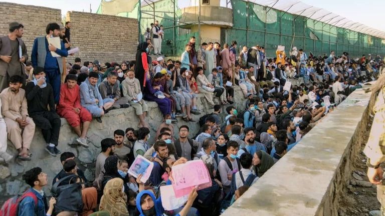 Crowds of people wait outside the airport in Kabul, Afghanistan, 25 August