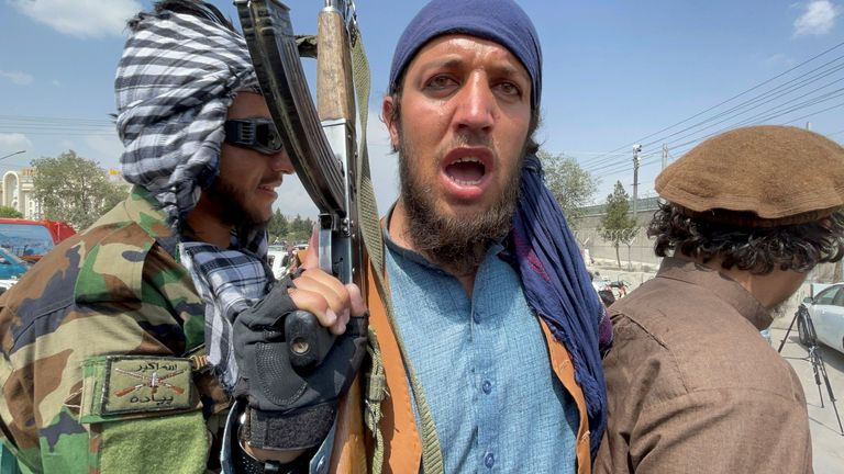 Taliban forces patrol near the entrance gate of Hamid Karzai International Airport, a day after U.S troops withdrawal, in Kabul
