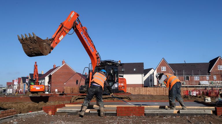 Construction workers work on a Taylor Wimpey housing estate