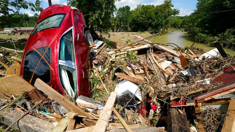 A car is among debris that washed up against a bridge over a stream in Waverly