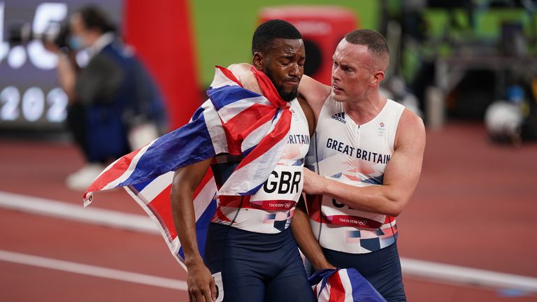 Nethaneel Mitchell-Blake is consoled by Richard Kilty after Team GB lost therelay gold medal to Italy