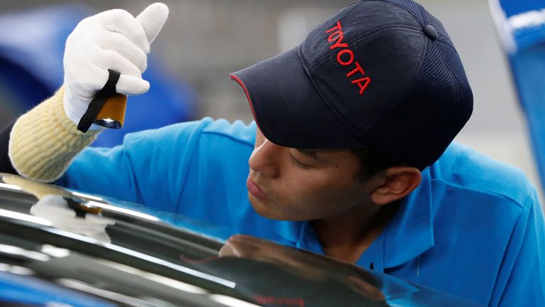 An employee of Toyota Motor Corp. works on the assembly line of Mirai fuel cell vehicle (FCV) at the company&#39;s Motomachi plant in Toyota, Aichi prefecture, Japan May 17, 2018. Picture taken May 17, 2018