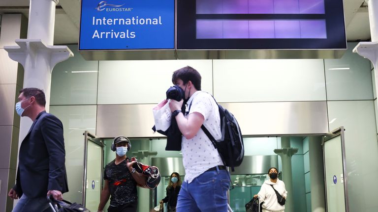 Travellers exit from an arrivals gate at St Pancras International station following the arrival of a Eurostar train from Paris