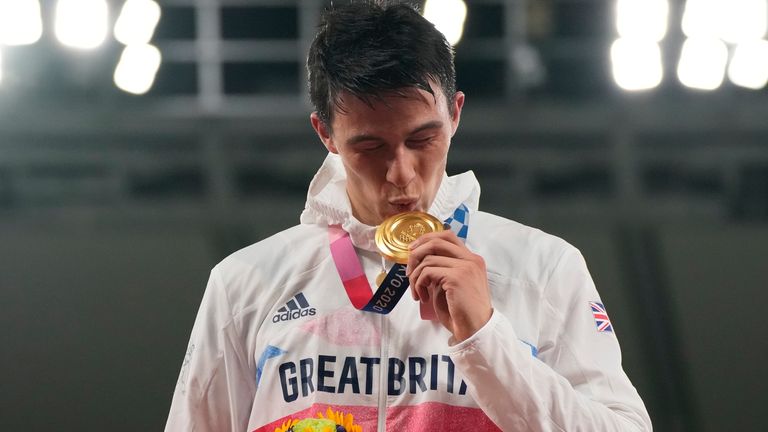 Joseph Choong of Britain celebrates on the podium during the medal ceremony for the men&#39;s modern pentathlon at the 2020 Summer Olympics, Saturday, Aug. 7, 2021, in Tokyo, Japan. (AP Photo/Hassan Ammar)