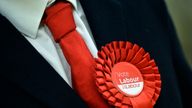 A Labour Party supporter wears a rosette in support of the political party during the election count for Basildon at the Sports Village in Basildon, Essex.