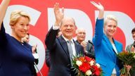 Social Democratic Party (SPD) leader and top candidate for chancellor Olaf Scholz, Mecklenburg-Western Pomerania state Prime Minister Manuela Schwesig and SPD member Franziska Giffey wave as they carry bouquets of flowers at their party leadership meeting, one day after the German general elections, in Berlin, Germany
