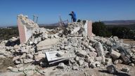 A camera operator films amid the rubble of a demolished church following an earthquake, in the town of Arkalochori on the island of Crete, Greece, September 27, 2021. REUTERS/Stefanos Rapanis