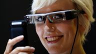 A model poses with 'Moverio BT-200' smart glasses of Epson on the media day of Photokina, the world's largest fair for imaging, in Cologne September 15, 2014. Each lens has its own display and is a premier development platform for apps of the future and hands-free scenarios, delivering large, 2D or 3D images. More than 1,000 exhibitors from 51 countries will show their latest products at the Photokina 2014 from September 16-21. REUTERS/Ina Fassbender (GERMANY - Tags: BUSINESS SCIENCE TECHNOLOGY 