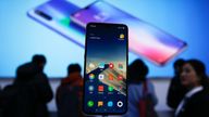 Xiaomi new model Mi 9 is displayed on an exhibition booth as invited guests try out the phones after its launch event in Beijing, Wednesday, Feb. 20, 2019. Xiaomi on Wednesday unveiled a thinner and lighter new model built with Ai triple camera that its Founder, Chairman and CEO Lei said has better performance comparable to Apple...s iPhone Xs and Huawei Mate 20. (AP Photo/Andy Wong)
