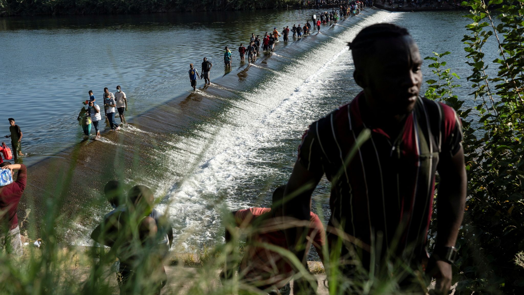Texas begs for help as 10,000 migrants camp in squalid conditions under ...
