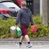 A man carrying containers at a petrol station in Bracknell, Berkshire