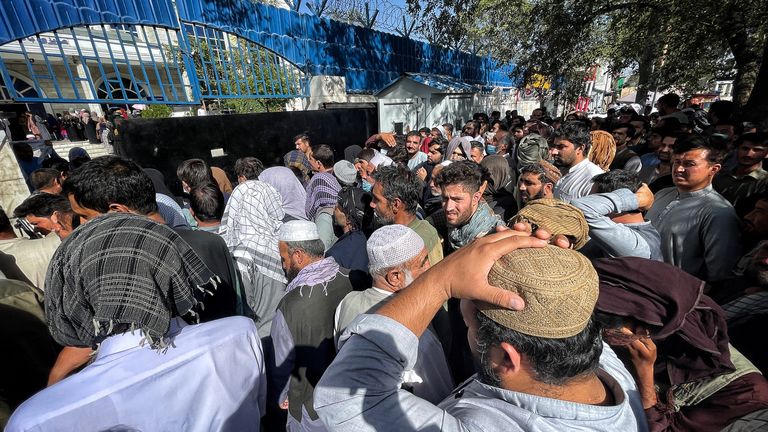 Huge queues of people waiting outside a bank in Afghanistan
