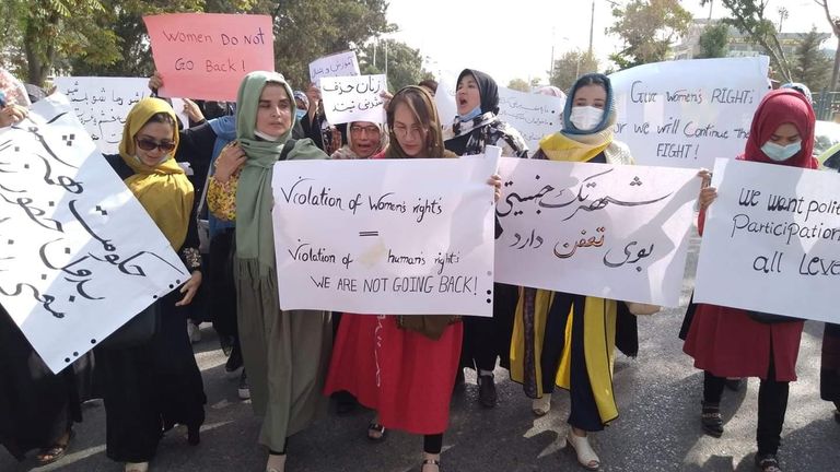 Women hold banners as they attend a demonstration in Mazar-e-Sharif, Afghanistan 