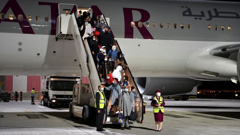 Passengers disembark a plane arriving from Afghanistan in 2021. Pic: Reuters