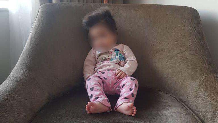 Ali&#39;s four-month-old daughter in the hotel room where they spent their quarantine 