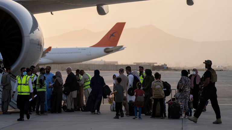 People board the Qatar Airways flight to Doha. Pic: AP