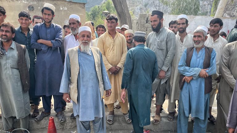 Afghans wait at the border to cross into Pakistan