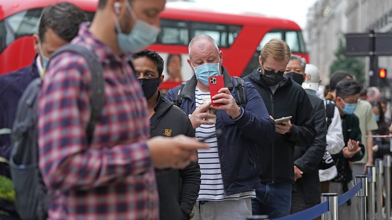 Customers queue to buy the new Apple iPhone 13 outside the tech giant&#39;s flagship store in Regent Street, central London