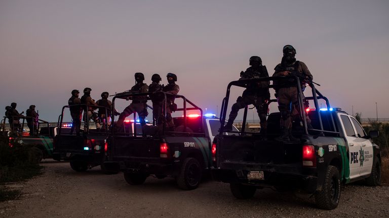 Mexican police stand guard near the Rio Grande river in Ciudad Acuna, Mexico
PIC:AP