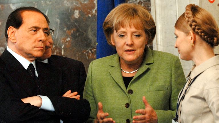 FILE - In this Thursday June 19, 2008 picture, Italian Prime Minister Silvio Berlusconi, left, listens on as German Chancellor Angela Merkel, center, speaks with Ukrainian Prime Minister Yulia Tymoshenko during a meeting of the European People&#39;s Party in Brussels. Despite celebrations planned Thursday, Aug. 26, 2010 
PIC:AP