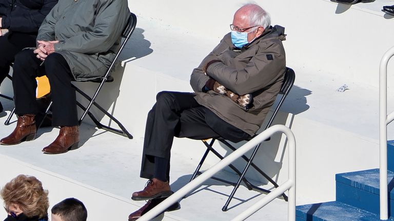 U.S. Senator Bernie Sanders sit socially distanced as he attends the Presidential Inauguration of Joe Biden on the West Front of the U.S. Capitol in Washington, U.S. January 20, 2021. Picture taken January 20, 2021. Caroline Brehman/Pool via REUTERS