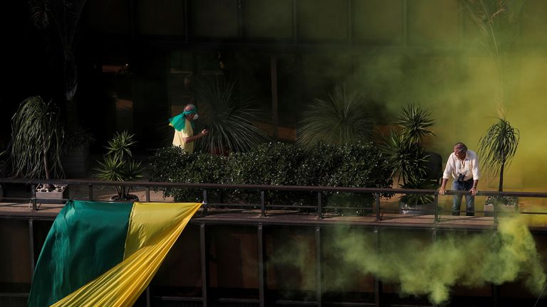 Supporters of Mr Bolsonaro listen to his speech from a building at Paulista Avenue in Sao Paulo