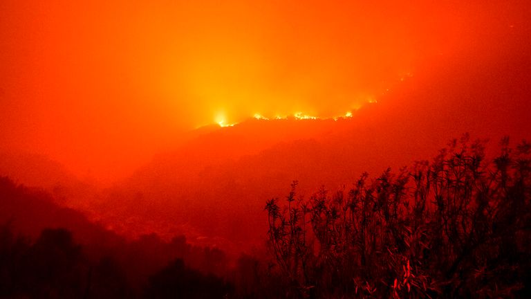 Flames from the KNP Complex Fire burn a hillside above the Kaweah River in Sequoia National Park. Pic: AP