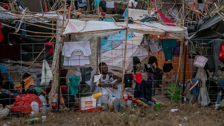 Migrants seeking asylum in the U.S. take shelter in make-shift migrant camp near the International Bridge between Mexico and the U.S., as they wait to be processed, in Del Rio, Texas, U.S. September 21, 2021. REUTERS/Go Nakamura